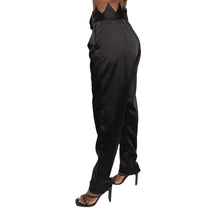 Load image into Gallery viewer, Description 100% poly Hand wash cold Zip fly with hook and bar closure Satin fabric Traingle shapes waistband  High waisted Color - black Size &amp; fit  Modeled in size   Model measurement:   MADINGO LUXE - PANTS Size Waist Hip Length 2	27	35	39 4	28	38	40 6	29	40	40.5 8	31	42	41 10	32	44	41.5
