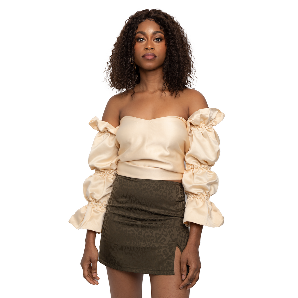 Cream puff sleeve with flared arms top. Open back tied closure. 